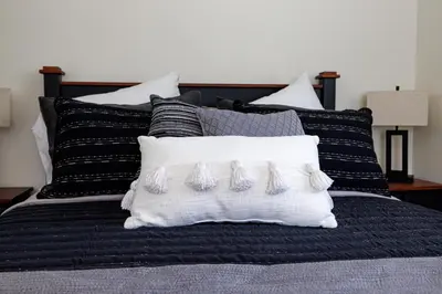 a black and white bed with four pairs of mitts on a pillow at The Cooper Home, Dogs Welcome! in Ephrata