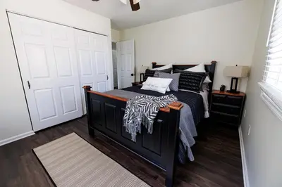 a bedroom with a black bed and a white door at The Cooper Home, Dogs Welcome! in Ephrata