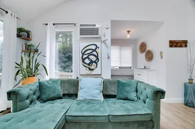 a living room with a green couch in a room at Green Acres Nature Escape in Long Pond