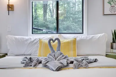 a blanket on a bed with a swan on it at Green Acres Nature Escape in Long Pond