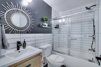 a bathroom with a shower and a toilet and a sink at Green Acres Nature Escape in Long Pond