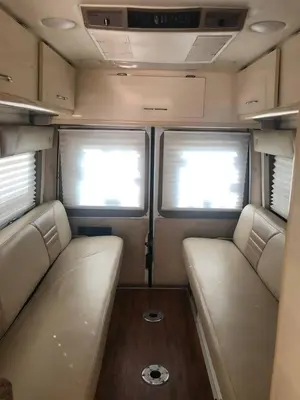 an interior of an rv with two seats and two windows at Private and cozy RV, direct bus to NYC Manhattan only 2 blocks away, MetLife Stadium FIFA World Cup 25 minutes away in Linden