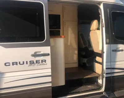 an open door of a white van with the door open at Private and cozy RV, direct bus to NYC Manhattan only 2 blocks away, MetLife Stadium FIFA World Cup 25 minutes away in Linden