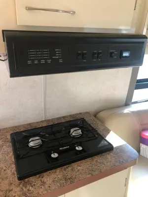 a stove top oven sitting on top of a counter at Private and cozy RV, direct bus to NYC Manhattan only 2 blocks away, MetLife Stadium FIFA World Cup 25 minutes away in Linden