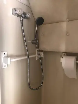 a shower head on a wall in a bathroom at Private and cozy RV, direct bus to NYC Manhattan only 2 blocks away, MetLife Stadium FIFA World Cup 25 minutes away in Linden