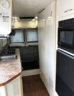 an rv kitchen with a stove and a refrigerator at Private and cozy RV, direct bus to NYC Manhattan only 2 blocks away, MetLife Stadium FIFA World Cup 25 minutes away in Linden