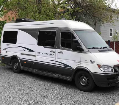 a white van parked in a parking lot at Private and cozy RV, direct bus to NYC Manhattan only 2 blocks away, MetLife Stadium FIFA World Cup 25 minutes away in Linden