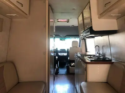 an rv with a kitchen and a stove in it at Private and cozy RV, direct bus to NYC Manhattan only 2 blocks away, MetLife Stadium FIFA World Cup 25 minutes away in Linden