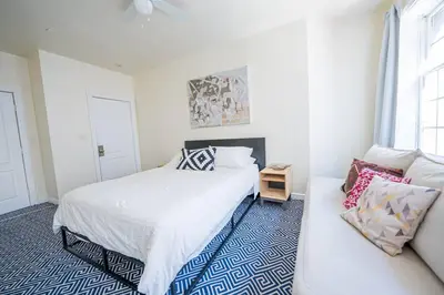 a white bedroom with a bed and a couch at Private Gramercy TownHouse 3BR 3BA with Terrace in New York