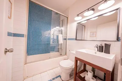a bathroom with a sink and a toilet and a shower at Private Gramercy TownHouse 3BR 3BA with Terrace in New York