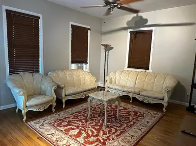 two couches and a table in a living room at Stunning 4BR home close to NYC in Teaneck