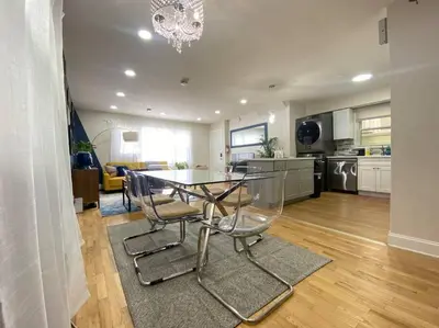 a dining room table and chairs in a kitchen at Live in NYC -20 Mins to Rockefeller, MoMA & World in Jersey City