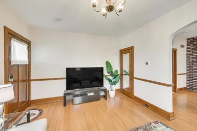 a living room with a flat screen tv on a wall at 5 Mi to Hersheypark Family Home with Game Room in Annville