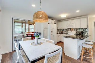 a kitchen and dining room with a table and chairs at Spacious Family Retreat Pocono Home with Deck in Albrightsville