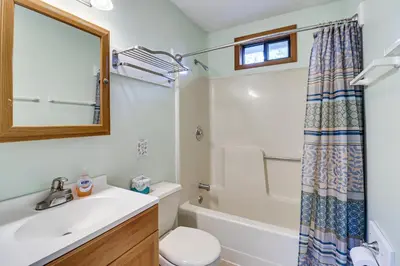 a bathroom with a sink and a toilet and a mirror at Spacious Family Retreat Pocono Home with Deck in Albrightsville
