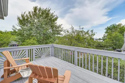 a balcony with two chairs and a table at Spacious Family Retreat Pocono Home with Deck in Albrightsville