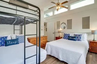 a bedroom with two bunk beds and a ceiling fan at Spacious Family Retreat Pocono Home with Deck in Albrightsville