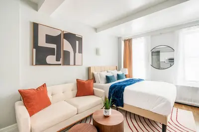 a bedroom with a bed and a couch at 73-703 New Studio UWS Doorman Gym in New York