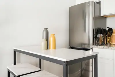 a white counter in a kitchen with a refrigerator at 73-703 New Studio UWS Doorman Gym in New York
