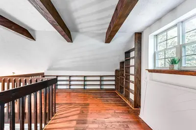 an empty room with a staircase and windows at Cozy Wooded Retreat Big Bass Lake Home in Lehigh