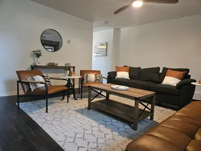 a living room with a couch and a table at Cozy & Modern 3-Bed Retreat - 8 Mins to Bridge St in Phoenixville