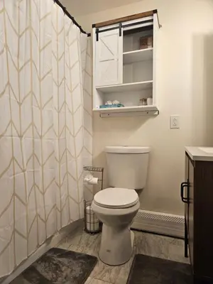a bathroom with a toilet and a shower curtain at Cozy & Modern 3-Bed Retreat - 8 Mins to Bridge St in Phoenixville
