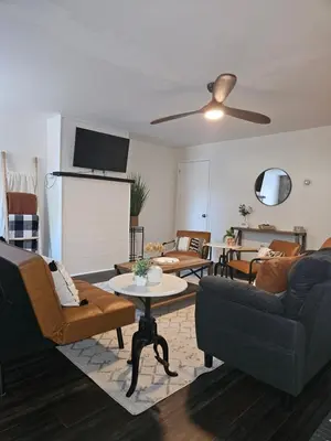 a living room with a couch and a table at Cozy & Modern 3-Bed Retreat - 8 Mins to Bridge St in Phoenixville