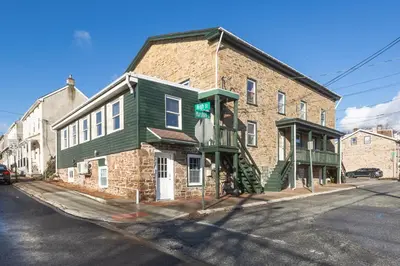 a brick building on the corner of a street at Rustic & Renovated 3 Bed - 8 Min Walk to Bridge St in Phoenixville