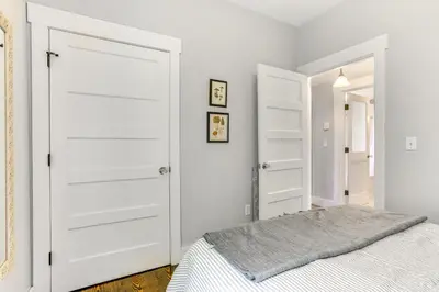 a bedroom with white doors and a bed at Lovely Country Retreat, 4 Mi to Dtwn Narrowsburg! in Narrowsburg