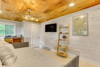 a bedroom with a bed and a tv on a wall at Lovely Country Retreat, 4 Mi to Dtwn Narrowsburg! in Narrowsburg