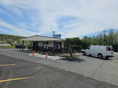 a white van parked in front of a fuel station at Motel 81 in Dalton