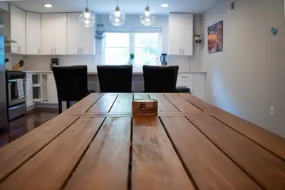 a kitchen and dining room with a wooden table at Stylish 3BR w Pool Table & Garage in Philadelphia