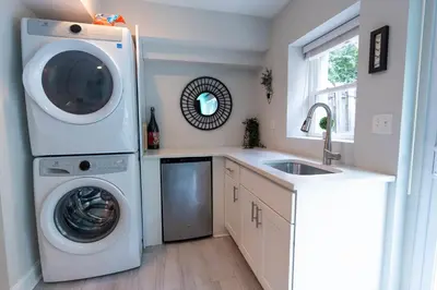a kitchen with a washing machine and a sink at Stylish 3BR w Pool Table & Garage in Philadelphia