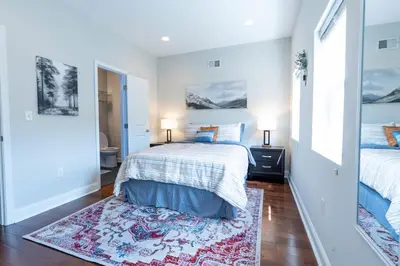 a bedroom with two beds and a rug at Stylish 3BR w Pool Table & Garage in Philadelphia