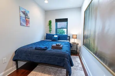a bedroom with a blue bed with a teddy bear on it at Stylish 3BR w Pool Table & Garage in Philadelphia