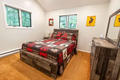 a bedroom with a bed in a room with windows at Home Tucked into Towamensing Trails in Albrightsville
