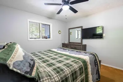 a bedroom with a bed and a ceiling fan at Home Tucked into Towamensing Trails in Albrightsville