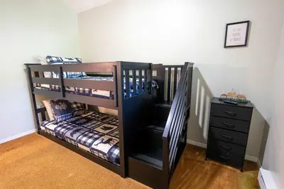 a black bunk bed in a room with a dresser at Home Tucked into Towamensing Trails in Albrightsville