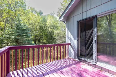 a balcony of a house with a large window at Home Tucked into Towamensing Trails in Albrightsville