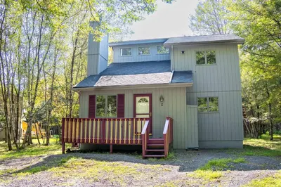 a small house with a bench in front of it at Home Tucked into Towamensing Trails in Albrightsville