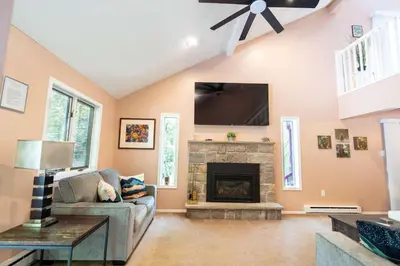 a living room with a fireplace and a tv at Home Tucked into Towamensing Trails in Albrightsville