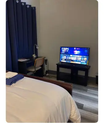 a bedroom with a bed and a flat screen tv at Cozy Room in Newark