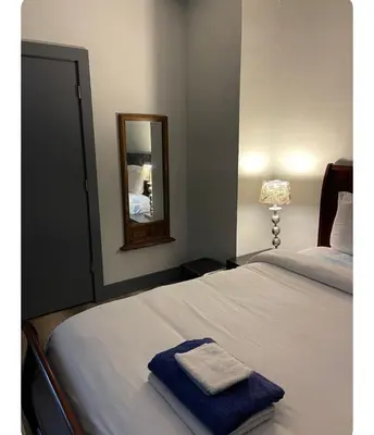 a bedroom with a bed with a blue towel on it at Cozy Room in Newark