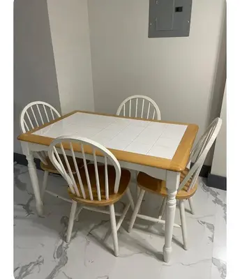 a wooden table with four chairs around it at Cozy Room in Newark