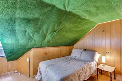 a bed in a room with a green ceiling at Playroom and Fenced Yard Mt Carmel Family Home! in Mount Carmel