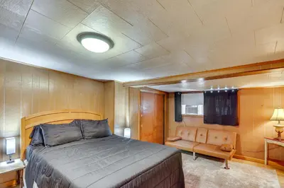 a bedroom with a bed and a couch in it at Playroom and Fenced Yard Mt Carmel Family Home! in Mount Carmel