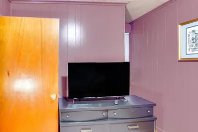 a tv on top of a dresser in a room at Playroom and Fenced Yard Mt Carmel Family Home! in Mount Carmel