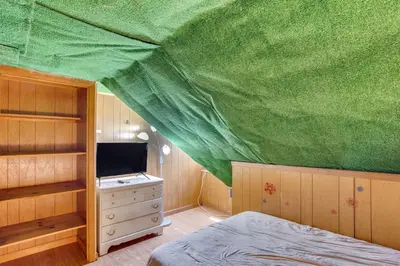 a bedroom with a bed and a green ceiling at Playroom and Fenced Yard Mt Carmel Family Home! in Mount Carmel