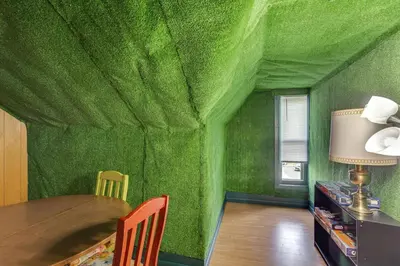 a green room with a table and a green wall at Playroom and Fenced Yard Mt Carmel Family Home! in Mount Carmel