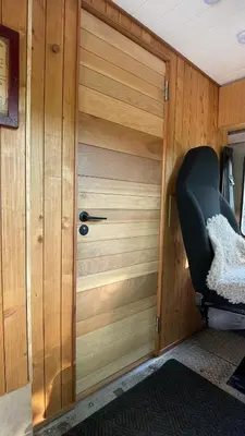a wooden door with a chair in a room at City Hideaway, Off Grid Luxe in Lancaster
